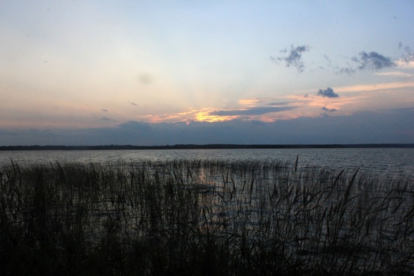 sunset behind clouds on lake kabetogama in voyaguers national park minnesota 