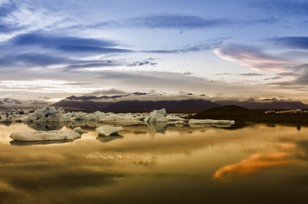 sunset icebergs water