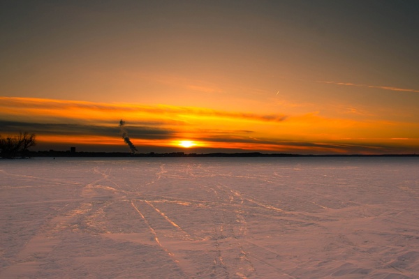 sunset over the ice on lake mendota in madison wisconsin