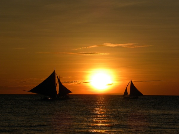 sunset sailing boats