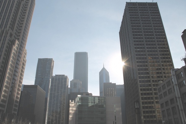 tall skyscrapers with sun in clear sky