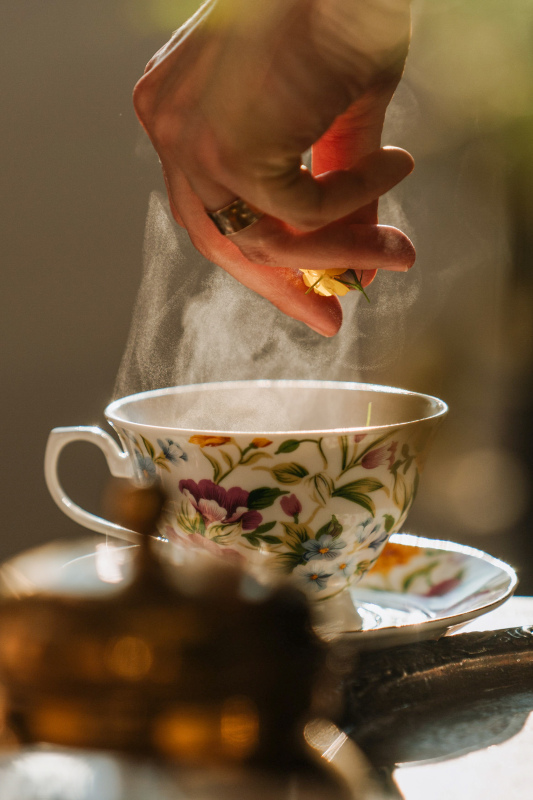 tea time picture dynamic closeup hand cup vapor