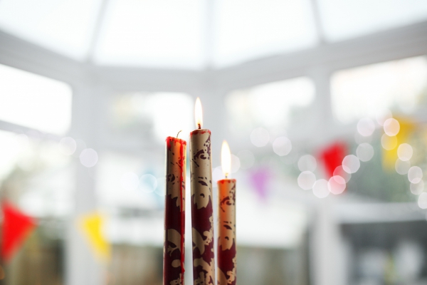 three burning christmas candles