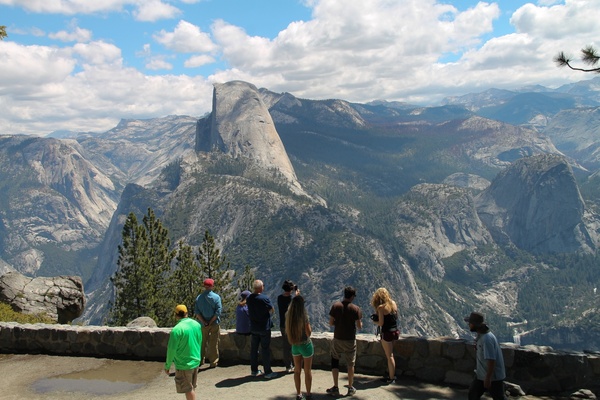 tourists looking at half dome