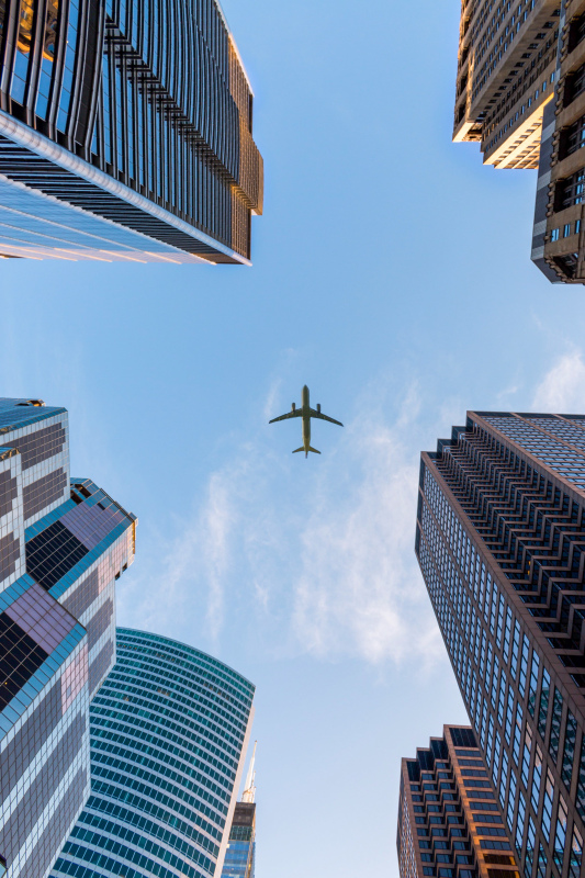 travel picture modern airplane sky buildings lower view 