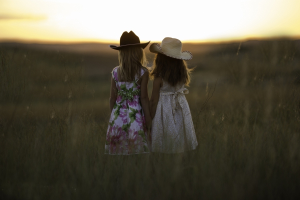 two girl standing on a field