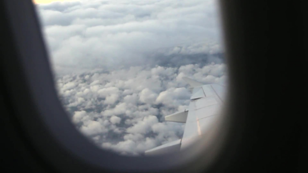 white cloudy scene outside of airplane window