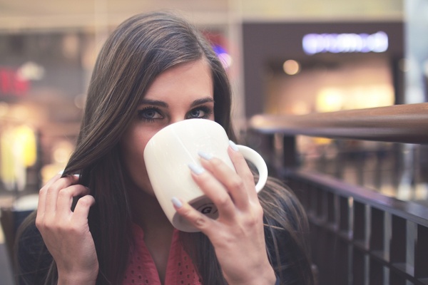 woman drinking a coffee from a cup