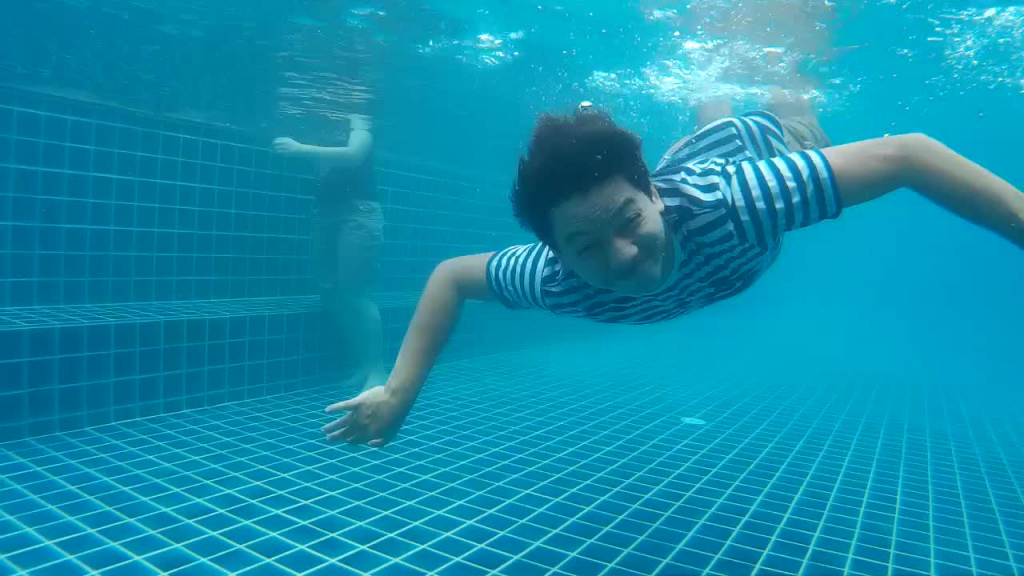 young man having fun with swimming pool