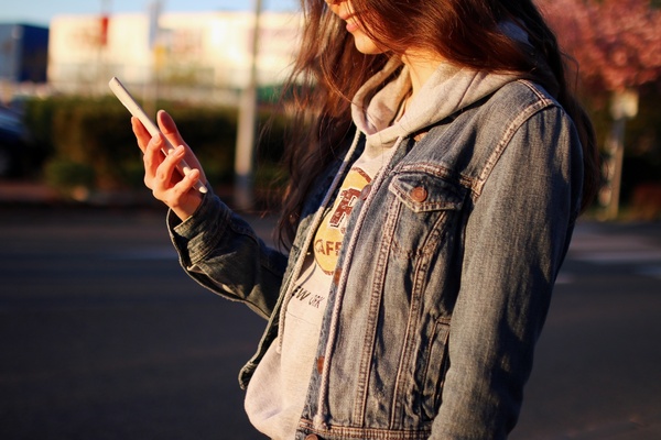 young woman using a smartphone on a city street