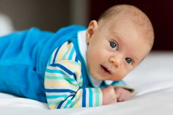 baby lying on a belly