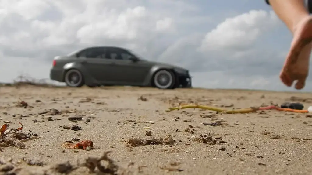 bokeh clip of man driving car on sand