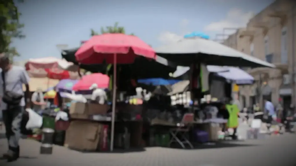 bokeh clip of pedestrians walking on city market