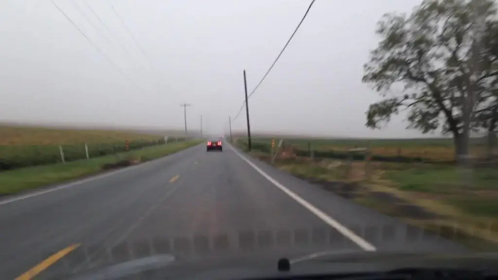 car driving fast on countryside road