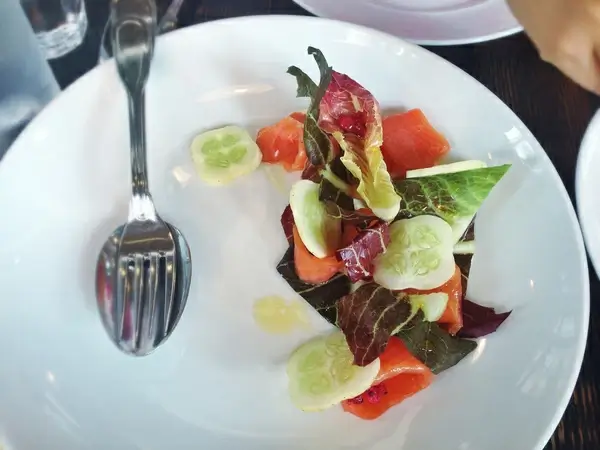 chamomile cured salmon with salted berries and cucumber