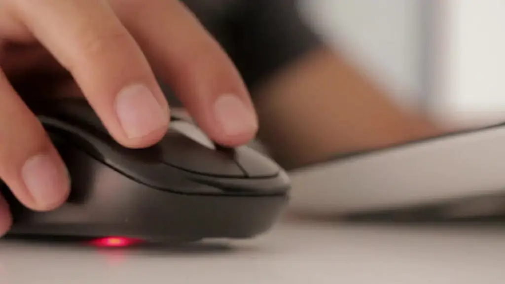 closeup of hands moving computer mouse