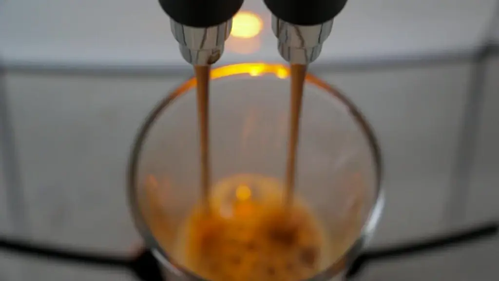 closeup of pouring coffee from machine