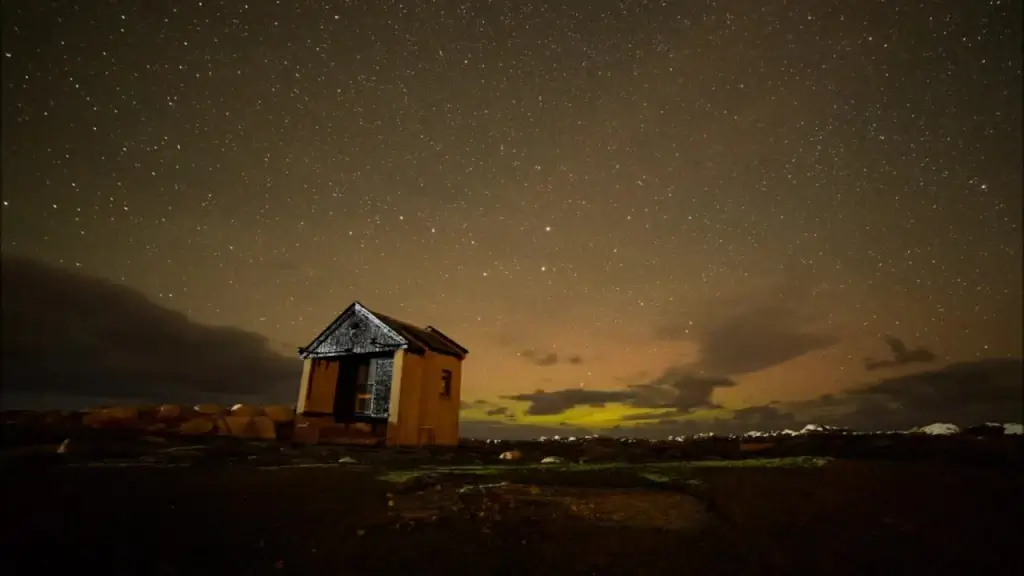 clouds and stars motion above cottage at night