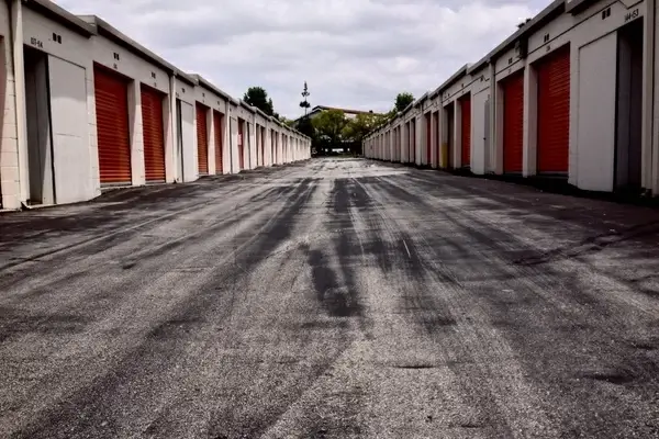 concrete pathway between storage buildings