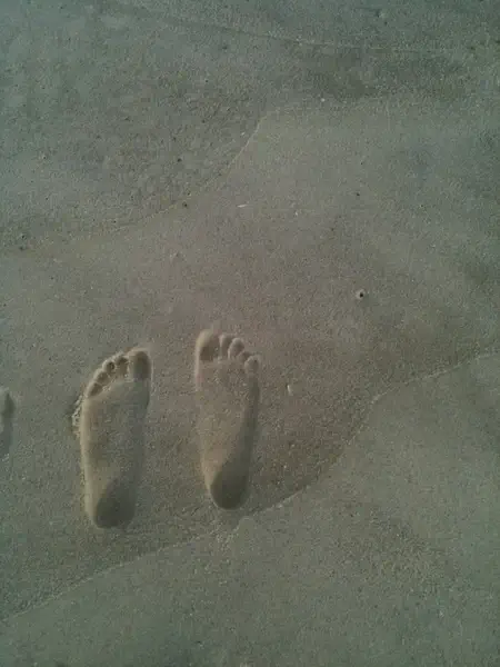 feet prints on sand