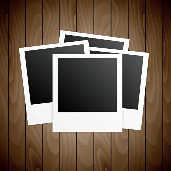four blanks photo frames on wooden