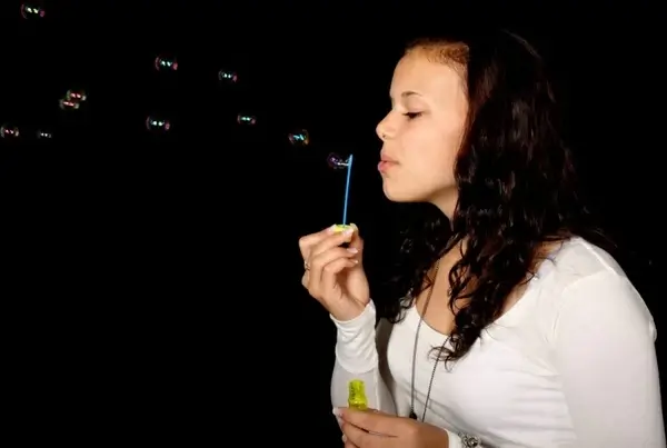 girl blowing bubbles