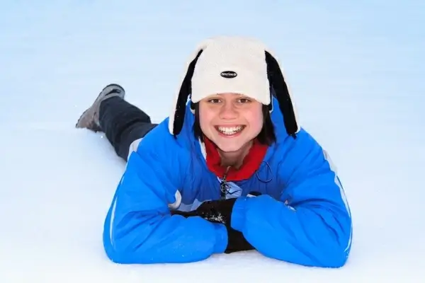 girl lying in snow