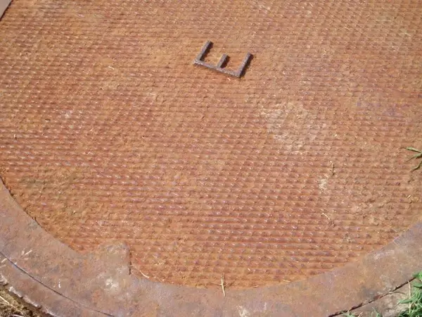 metal grate with letter e