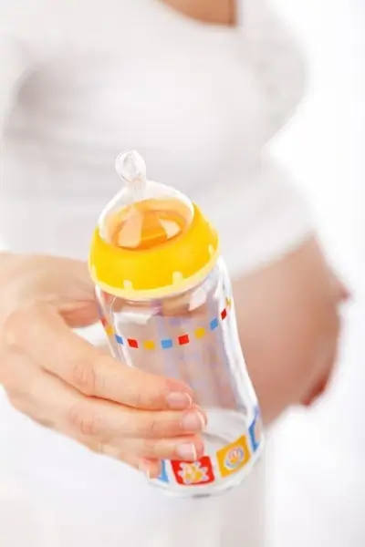 mother with a feeding bottle