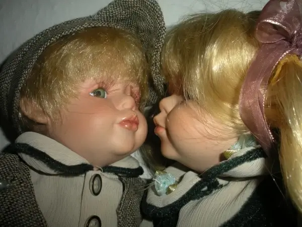porcelain dolls kissing close up