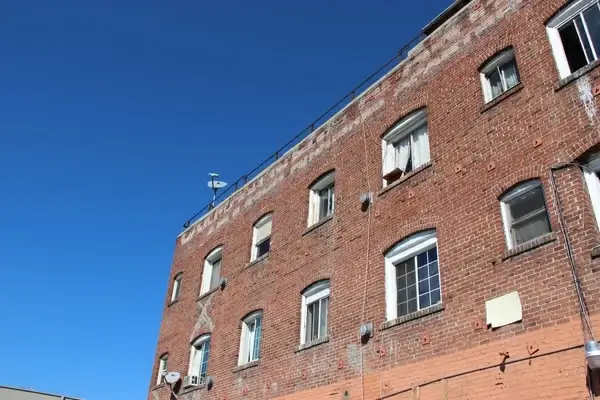 red brick apartment building on clear sky