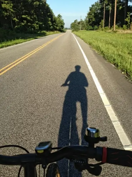 shadow of cyclist rural road cycling