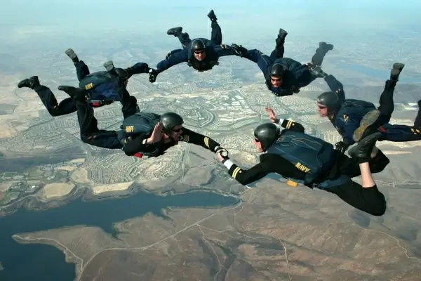skydivers sky clouds