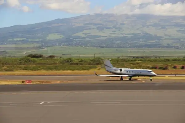 small jet airplane on runway at airport