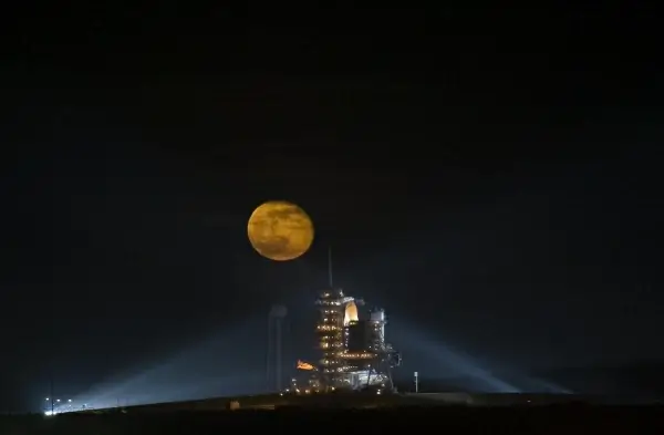 rocket launching pad under bright round moon 