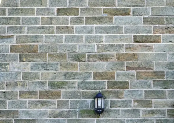 stone wall and the lamp