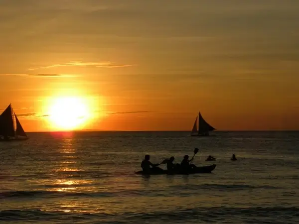 sunset sailing boats