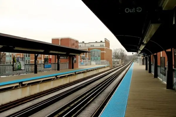 train tracks of empty train station on overcast day