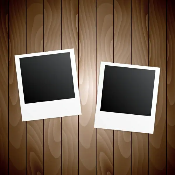 two blanks photo frames on wooden