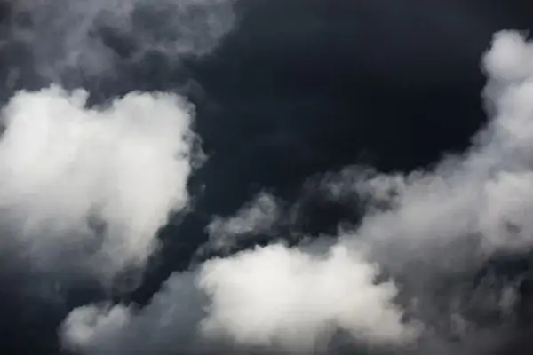 white clouds on dark sky