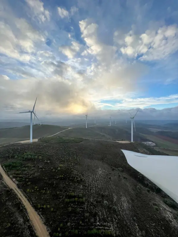 windmill scenery picture cloudy sky mountain range 