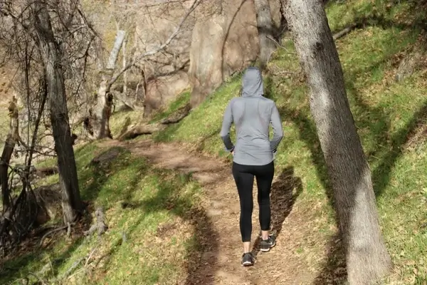 woman in hoodie 038 yoga pants walking through nature