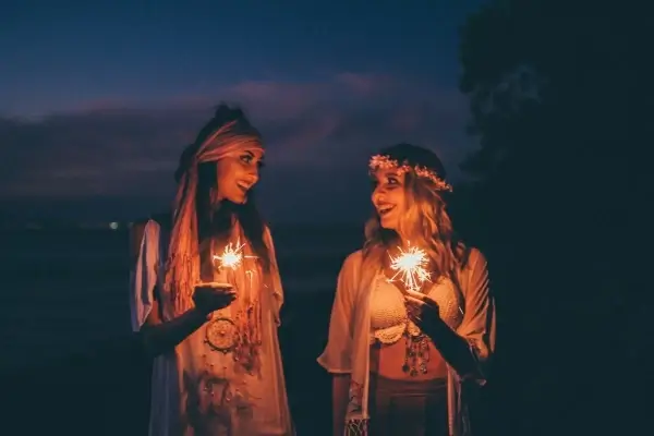 women holding sparklers