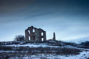 abandoned building in the winter in wisconsin with drone in sky