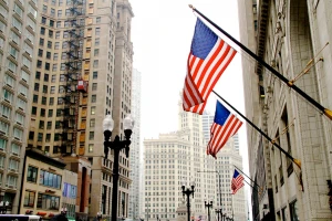 american flags on side of building in city