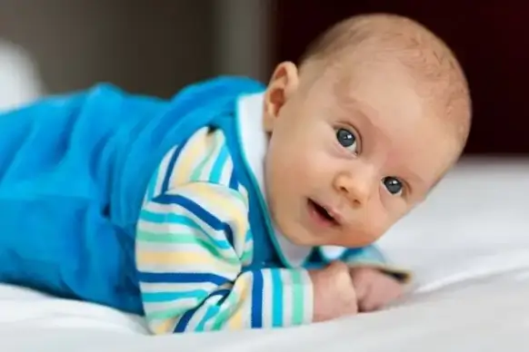baby lying on a belly