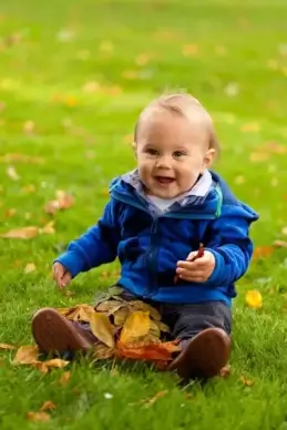 baby playing in fall