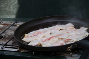 bacon cooking in skillet