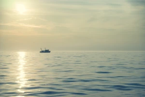 beach boat calm dawn dusk evening lake landscape
