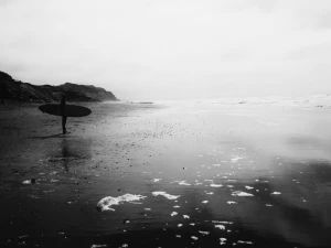 beach cliff hill ocean pebble person reflection sea